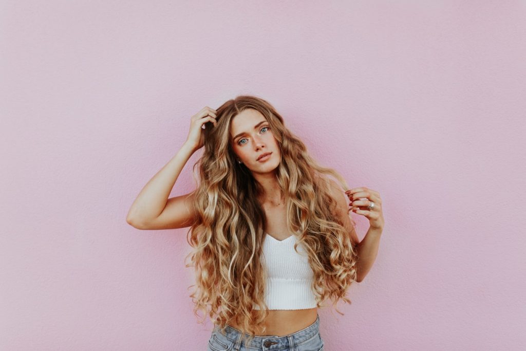 woman in front of pink wall