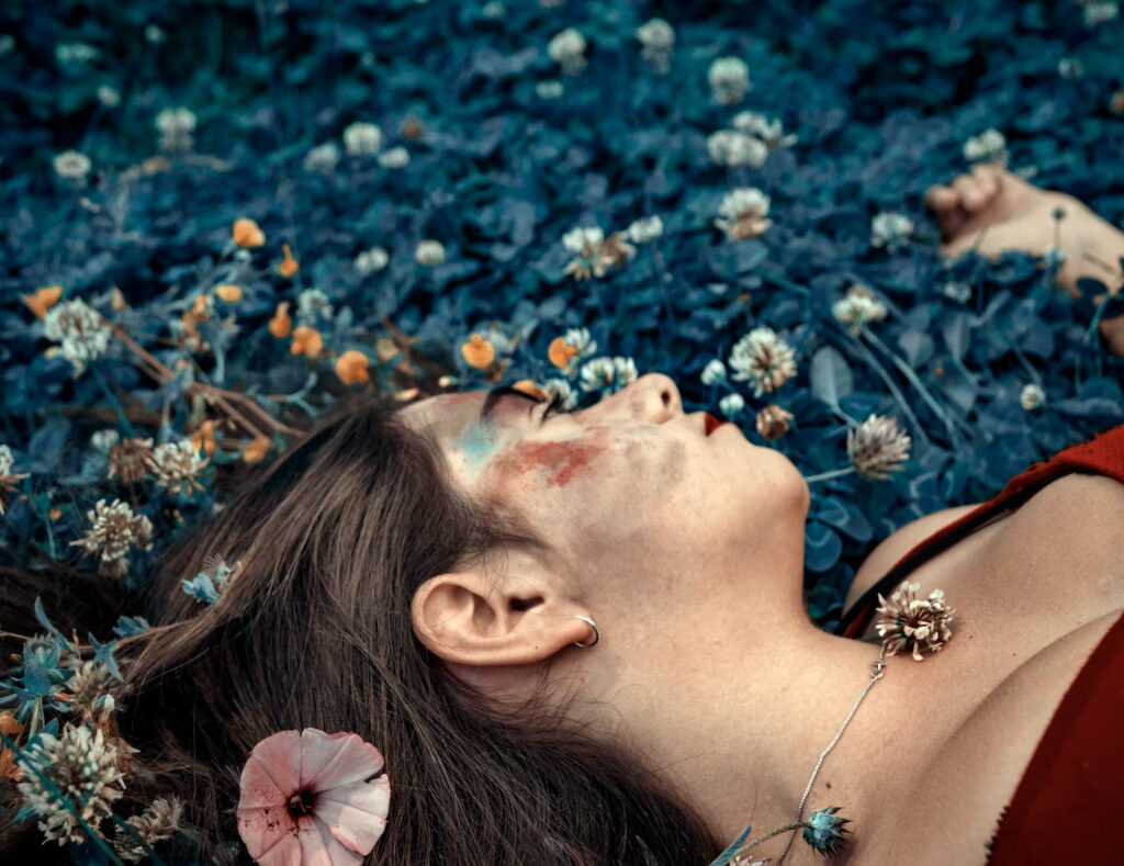 girl laying down in the field surreal colors