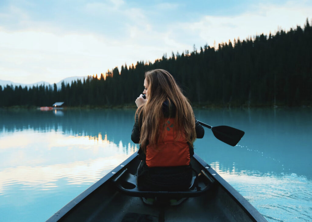 woman peddling on a blue lake