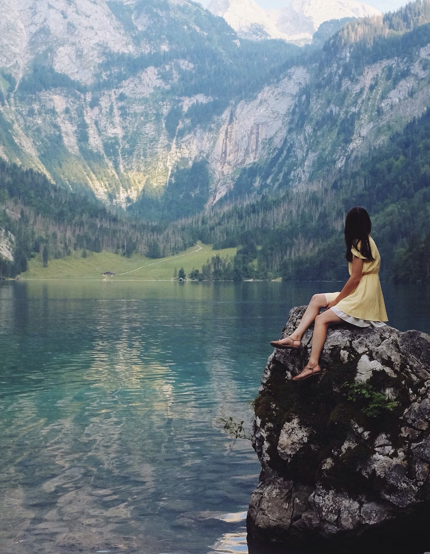 girl on a gorgeous lake surrounded by mountains