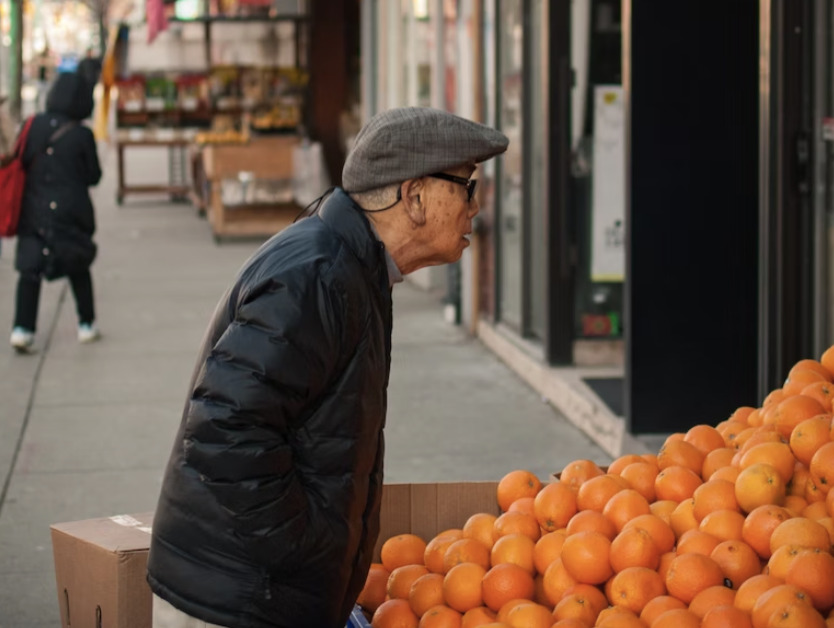 old man buying oranges