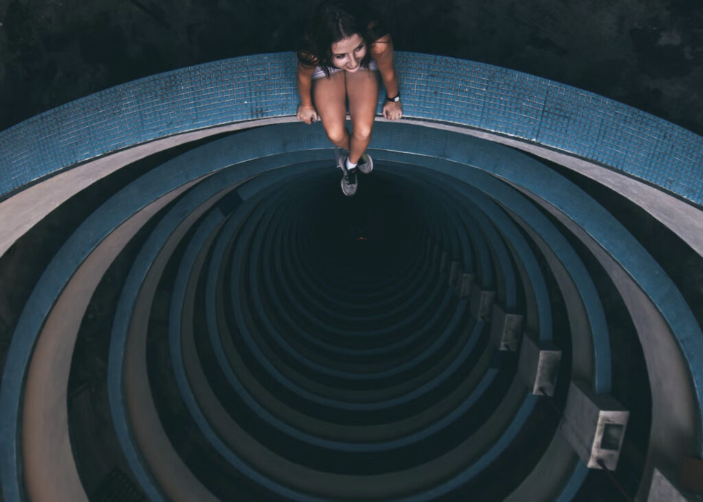 woman sitting on the edge of spiral stairway