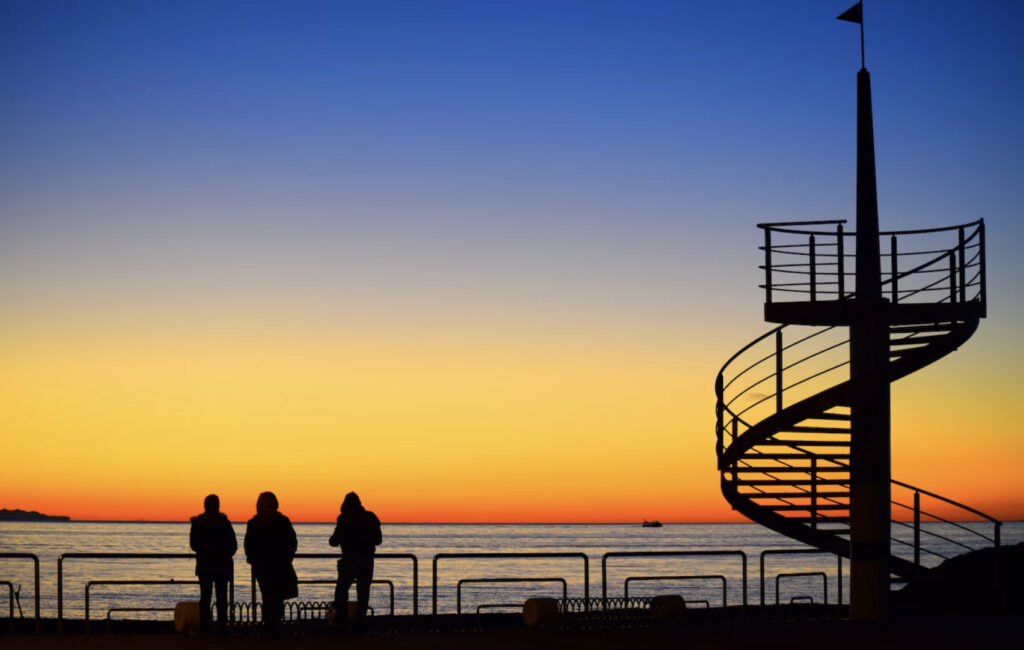 sunset three people spiral stairs