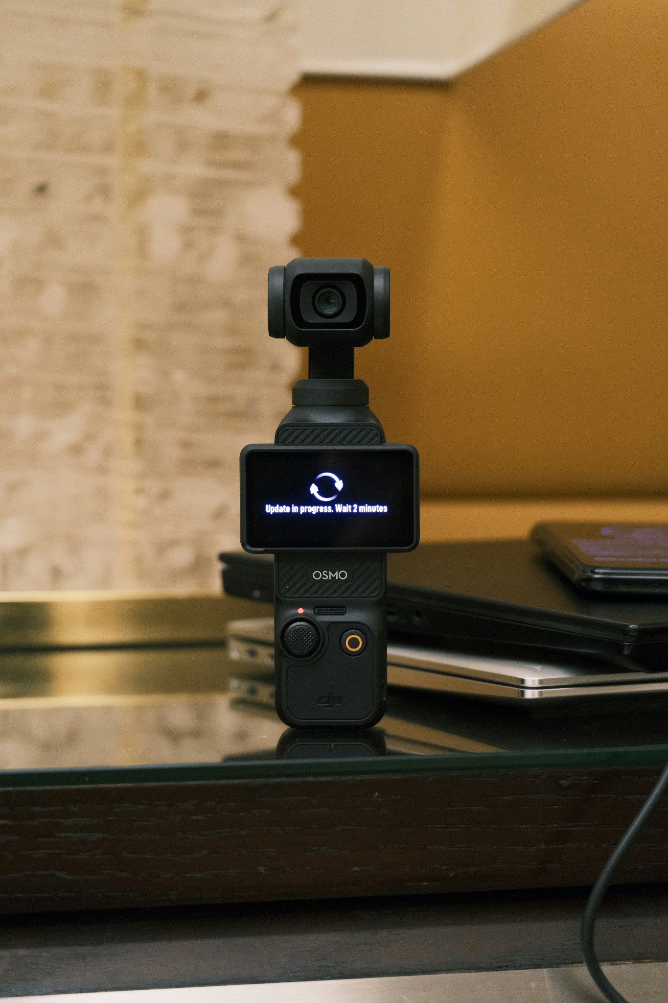 A DJI Pocket 3 camera standing upright and being updated