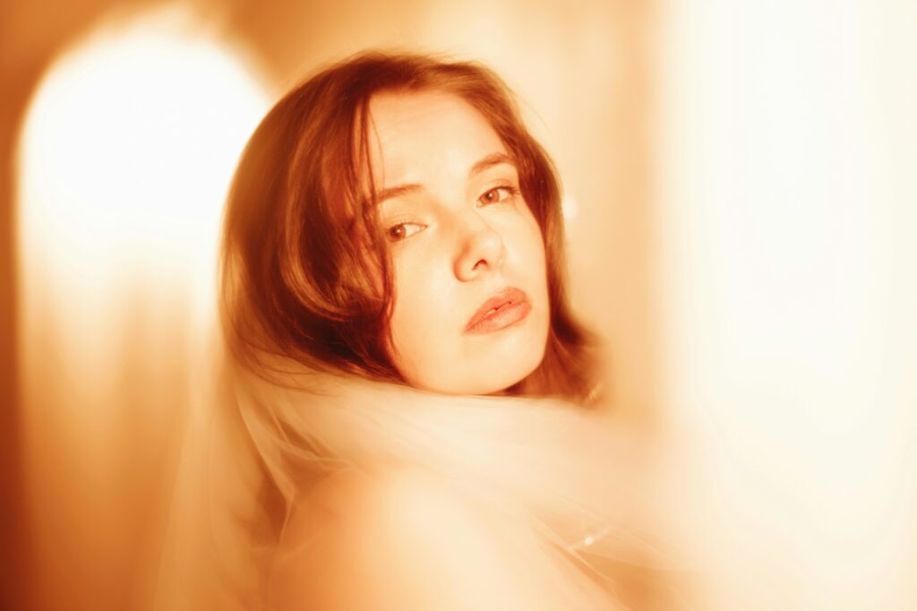 A dreamy soft focus portrait of a red haired girl