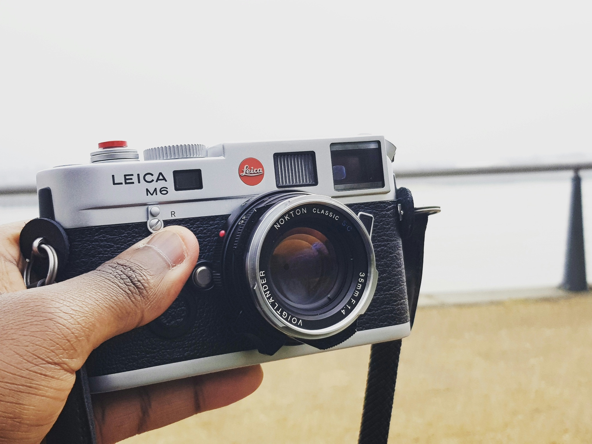 A Leica M6 film camera is someone's hand
