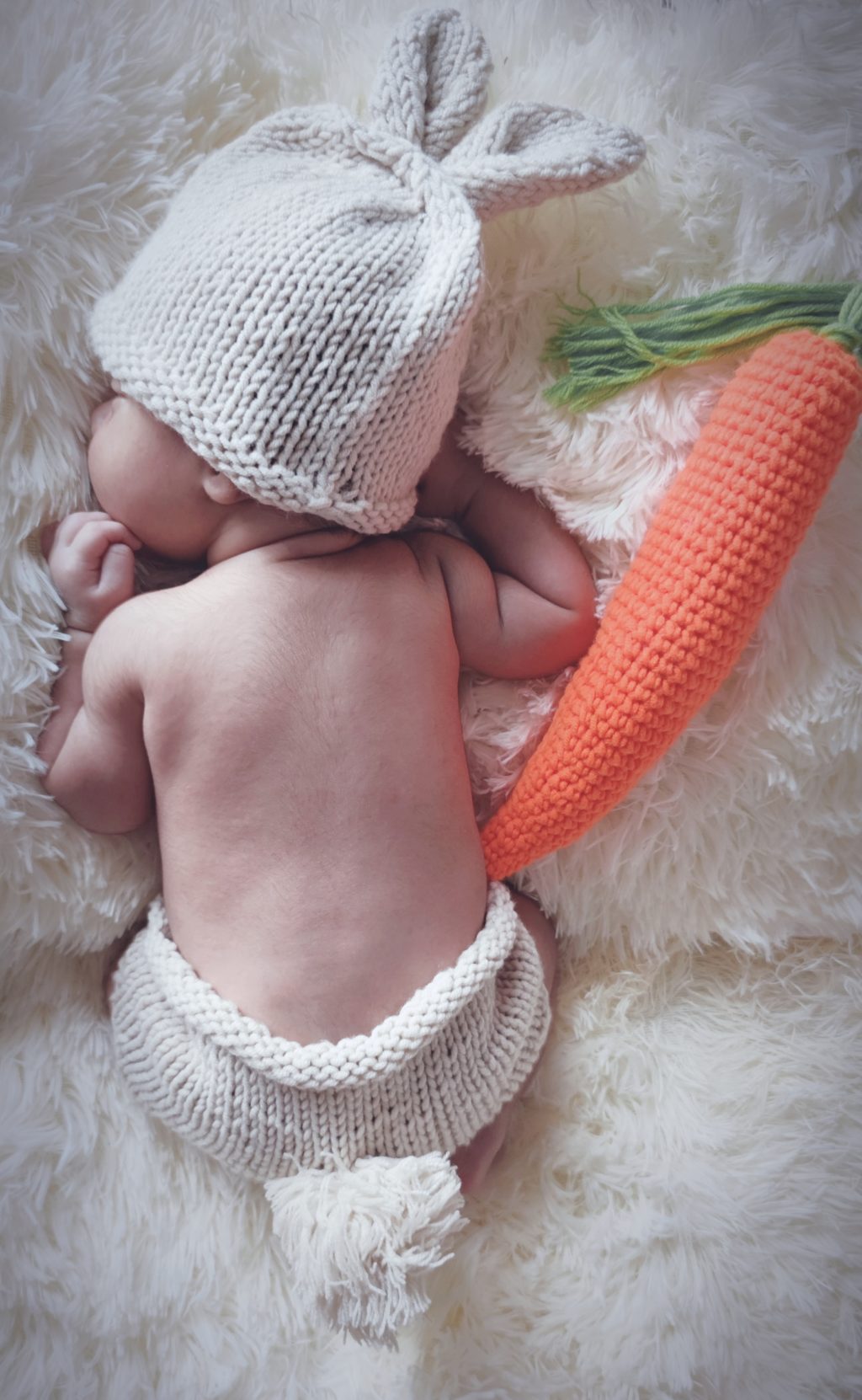 baby on soft white blanket