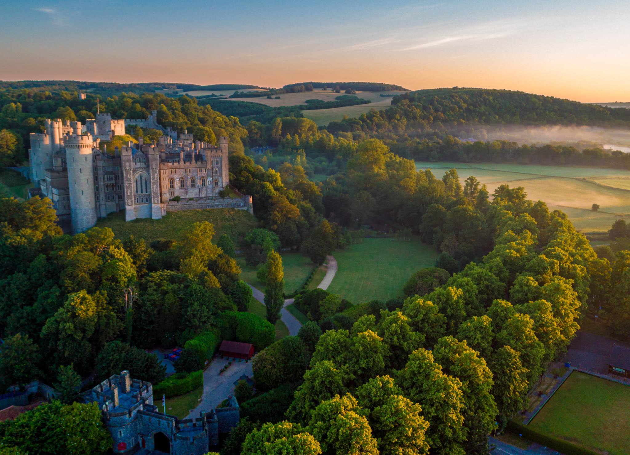Aerial image of Arundel Castle in West Sussex, England shot at dawn