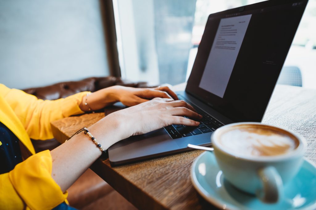 woman working on laptop with coffee