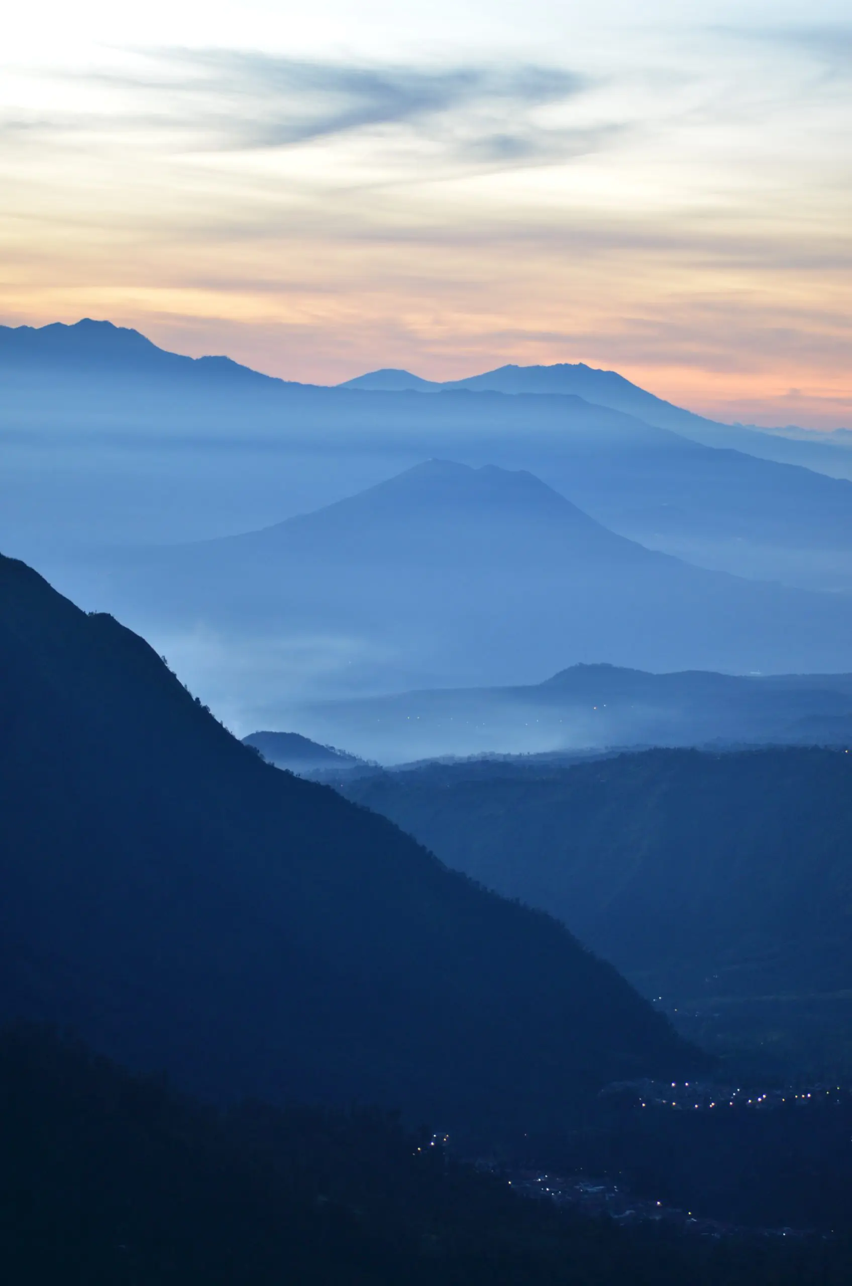 high angle photography of lighted city near mountain