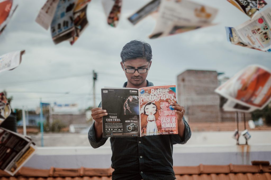 Man reading a photography magazine