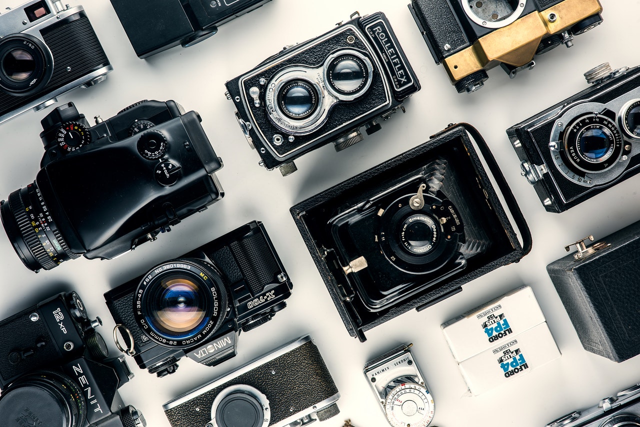 assorted black and gray cameras