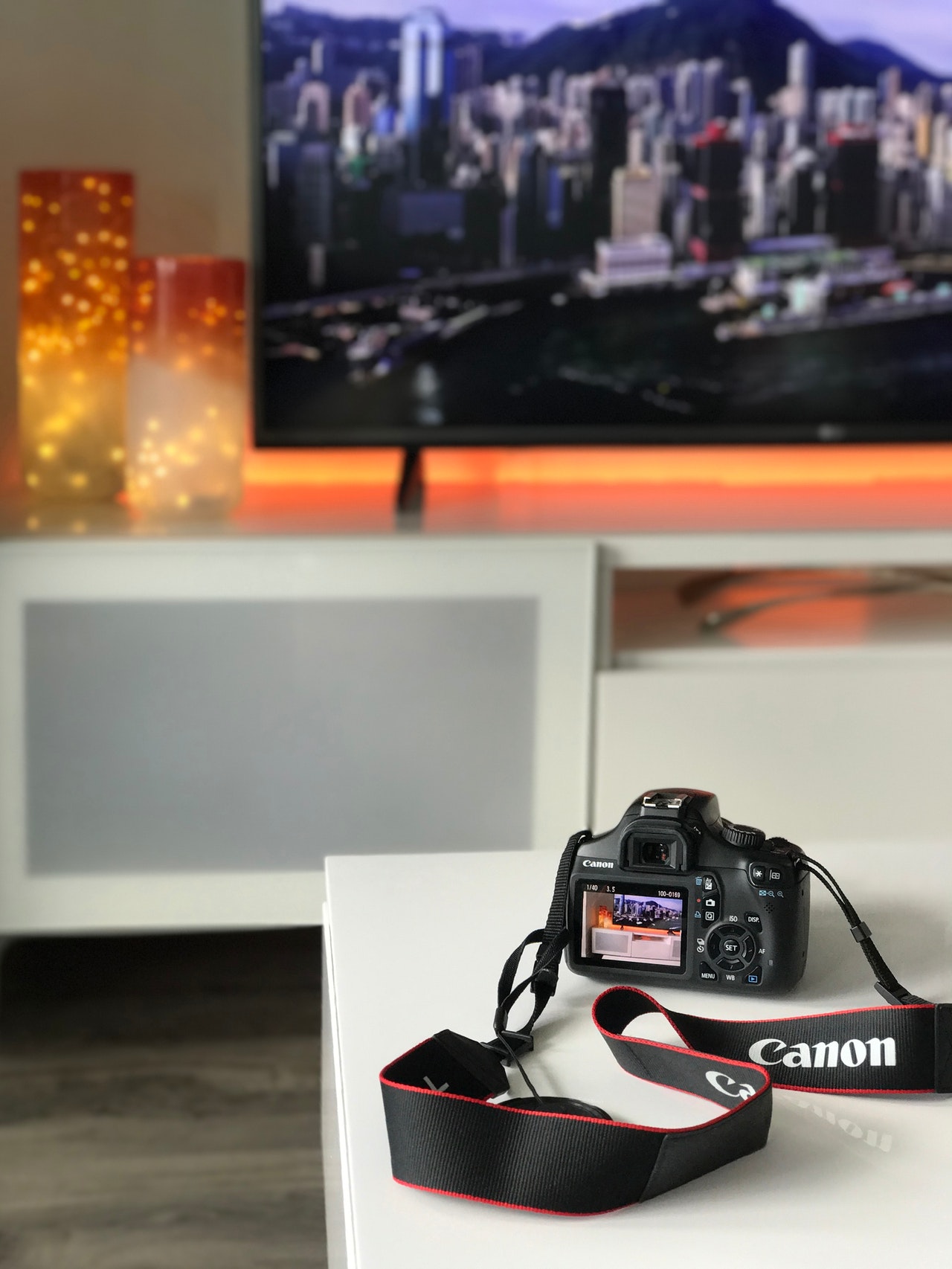 black canon camera on white wooden table