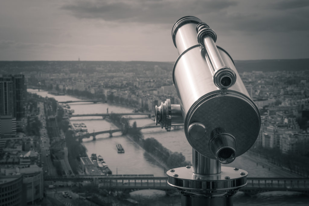 River and telescope and city in black and white