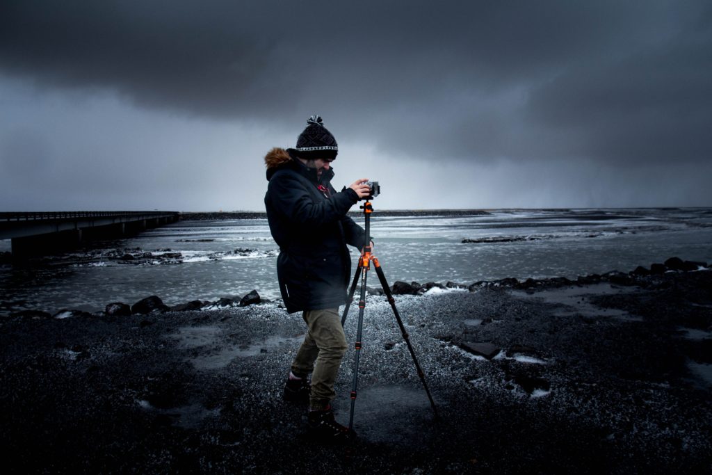 Photographer with tripod on beach