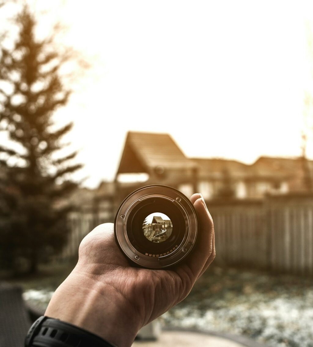 person holding lens