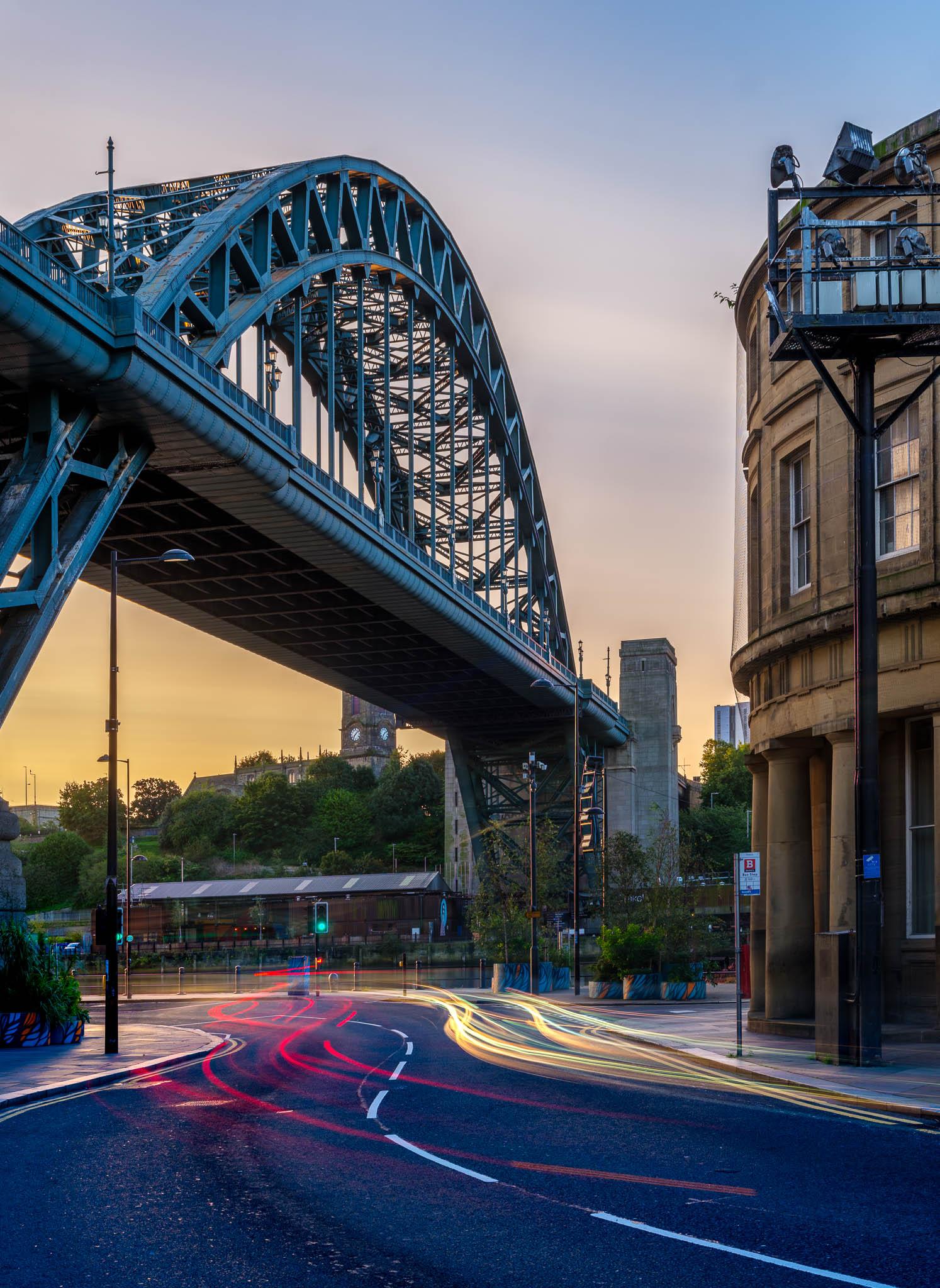 Car light trails under the Tyne Bridge in Newcastle during morning blue hour
