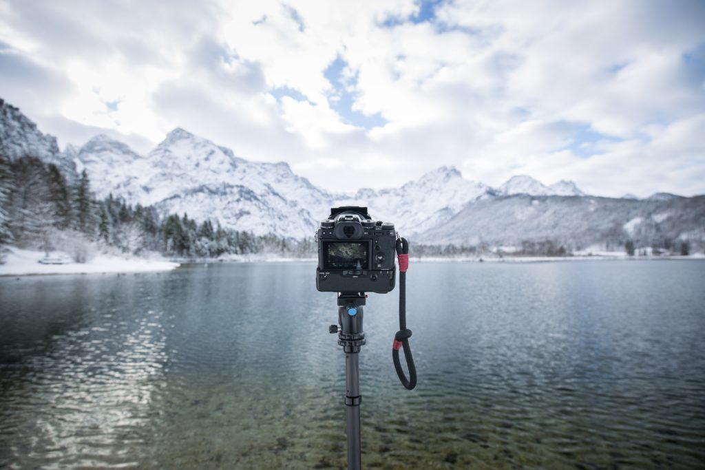 Camera on tripod in mountain landscape