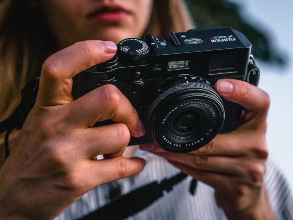 close up photo of woman holding camera