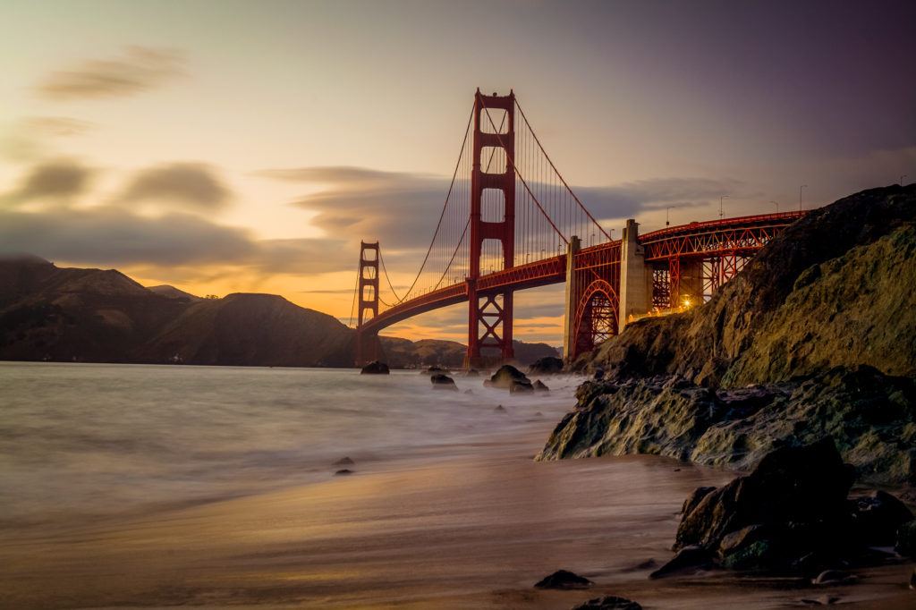 red bridge under white clouds