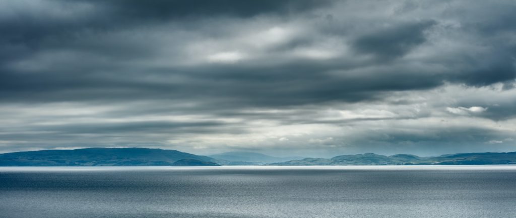 body of water under cloudy sky during daytime