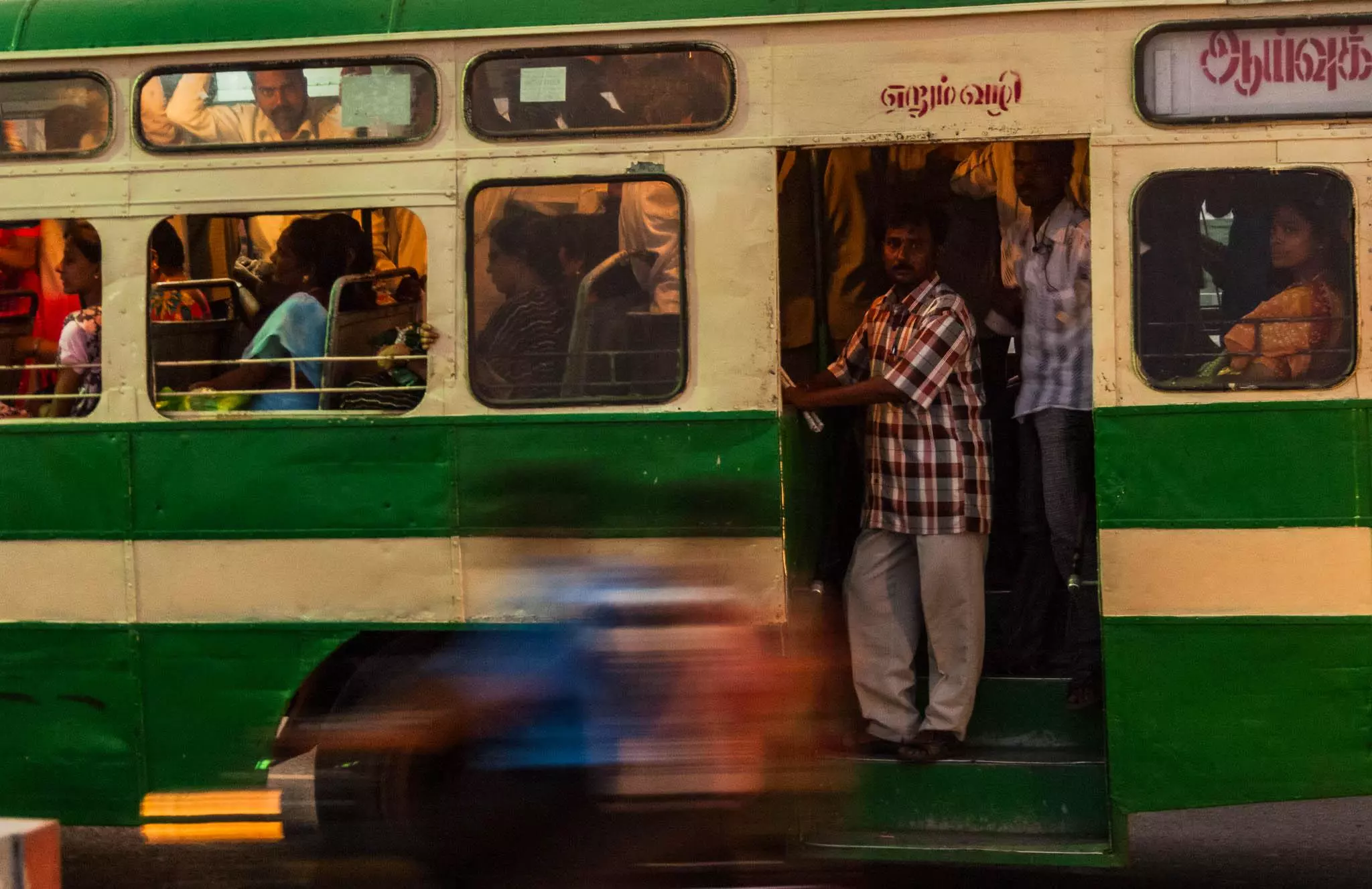 Commuters on a speeding bus in Chennai India