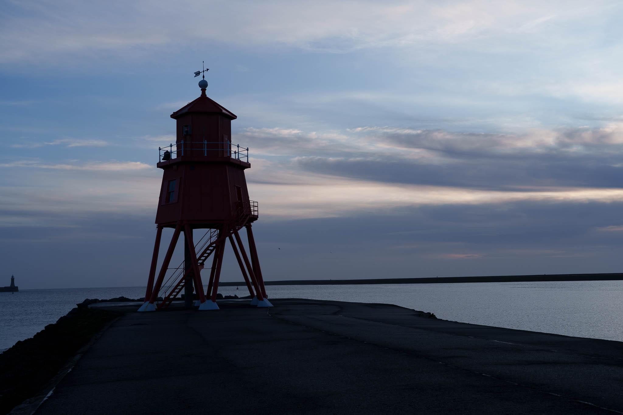 Dark, moody image of the Herd Groyne Lighthouse in South Shields, UK