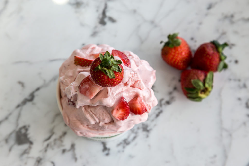 a group of strawberries on a white surface