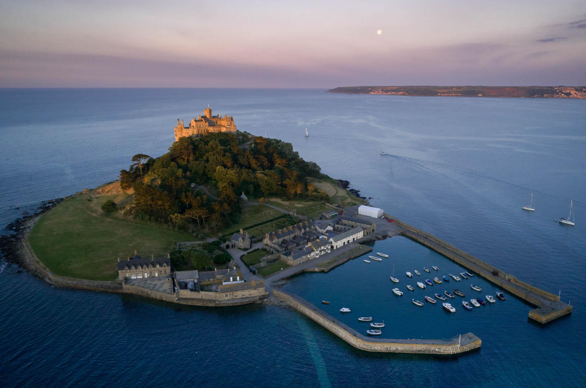 Drone image of St Michaels Mount in Cornwall taken during the morning blue hour