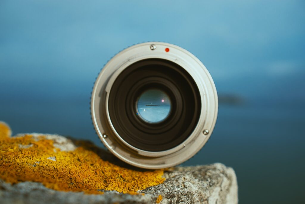 Camera lens perched on a rock