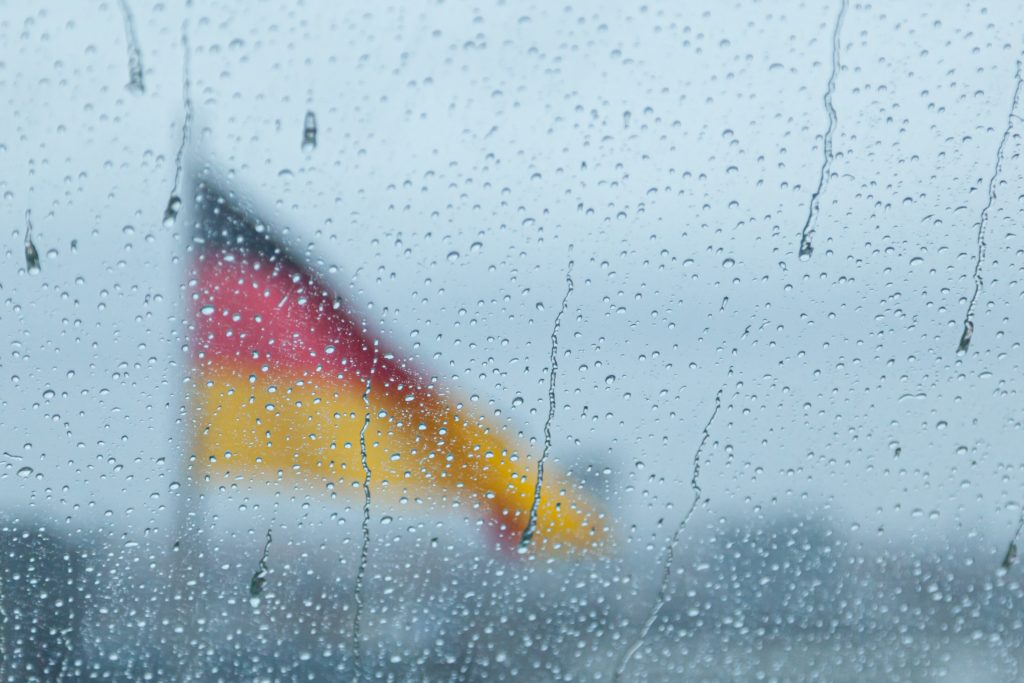 Defocused gemran flag through rainy window