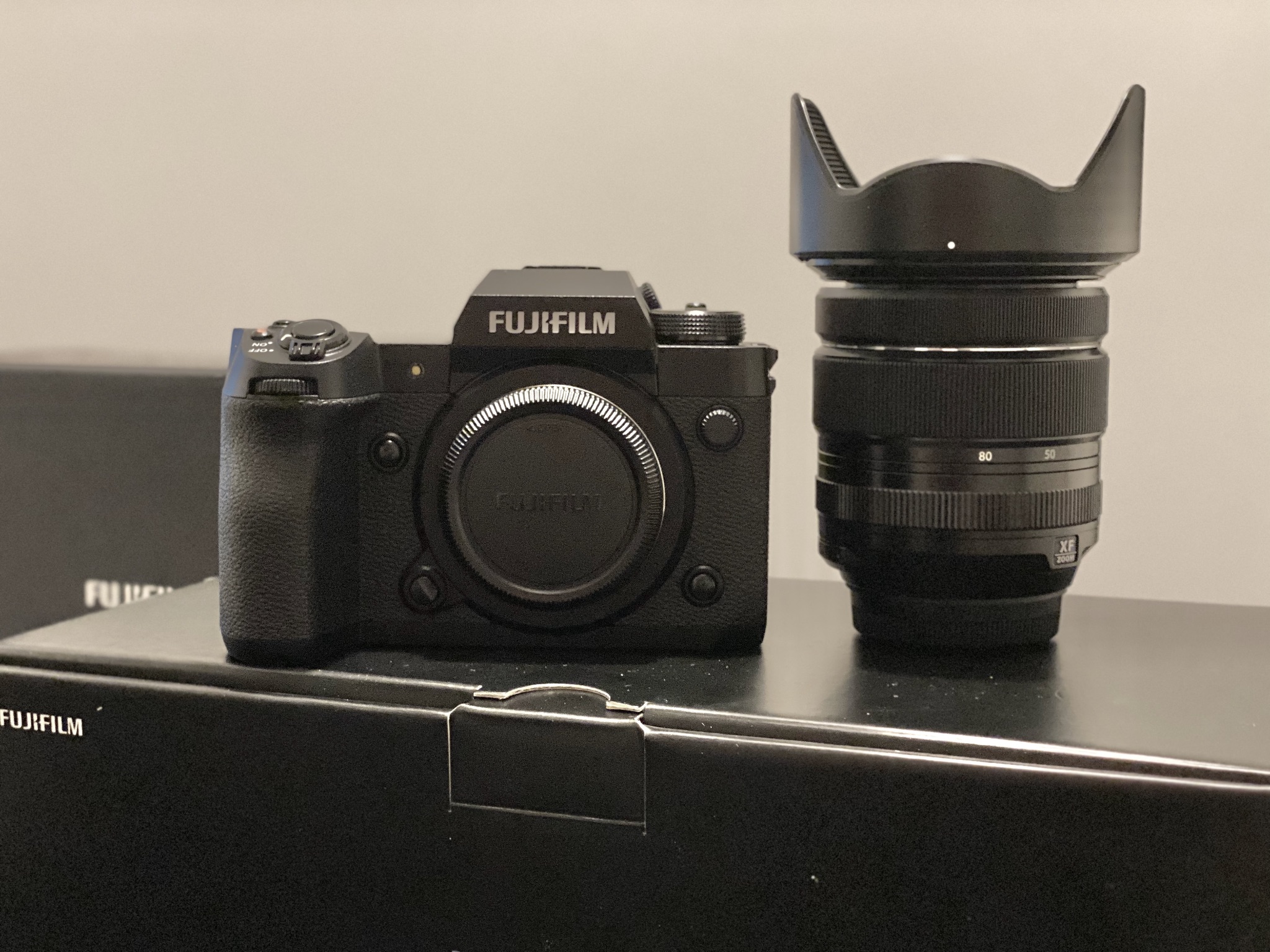 Fuji camera and lens sitting on Fuji box