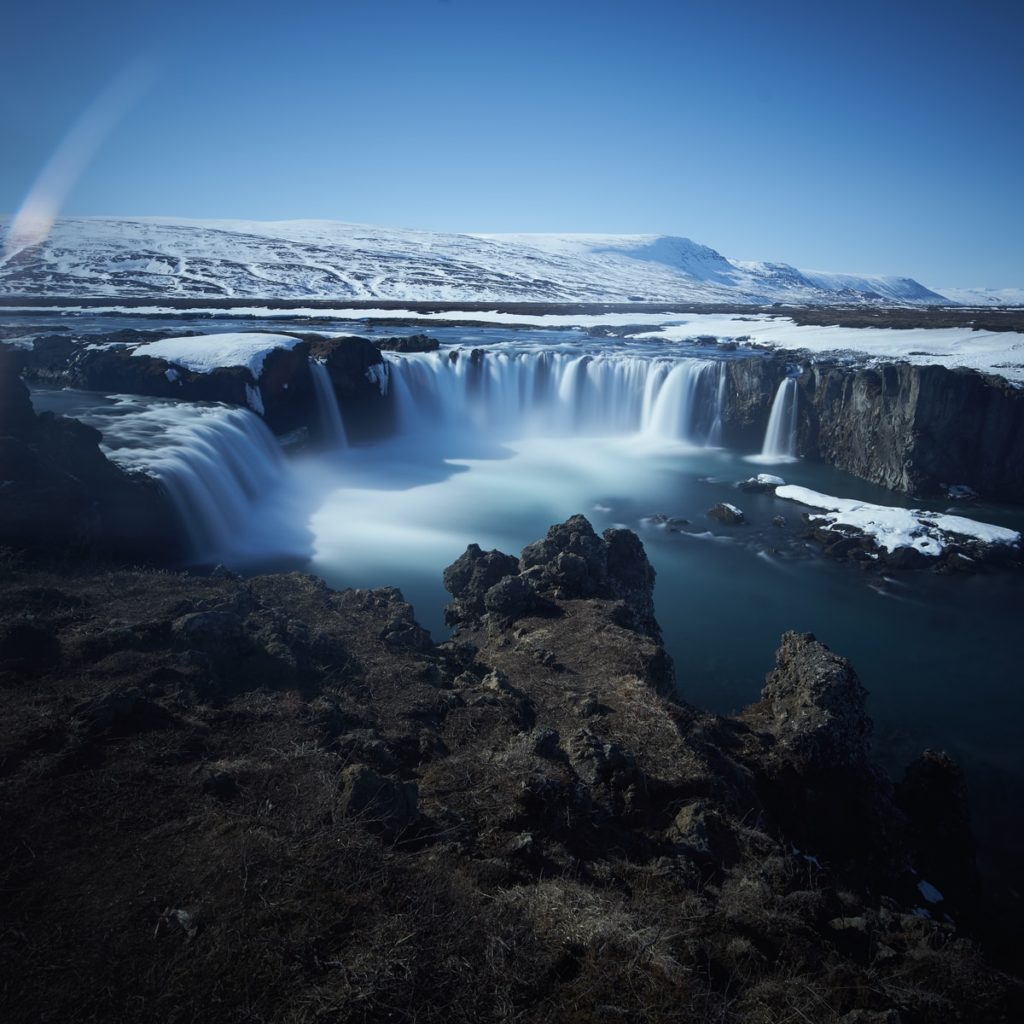 waterfalls near a land during daytime