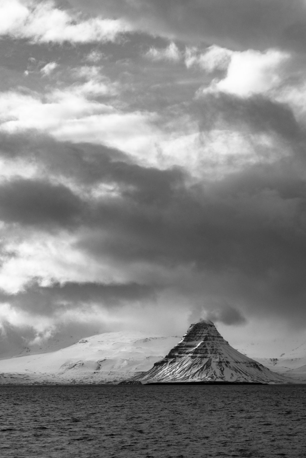 grayscale mountain and clouds