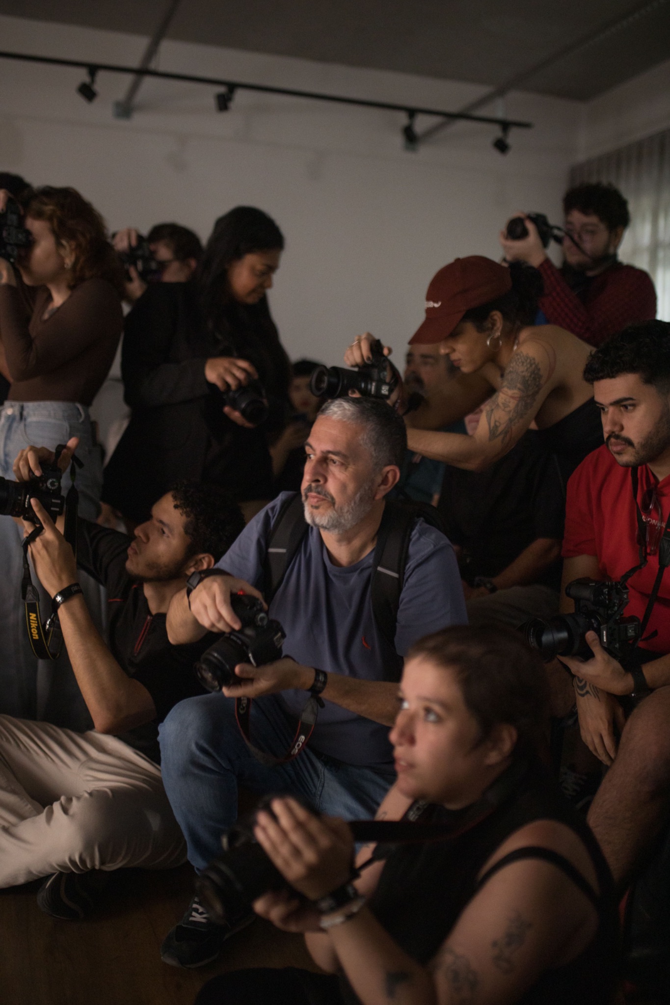 Group of photographers indoors shooting the same subject