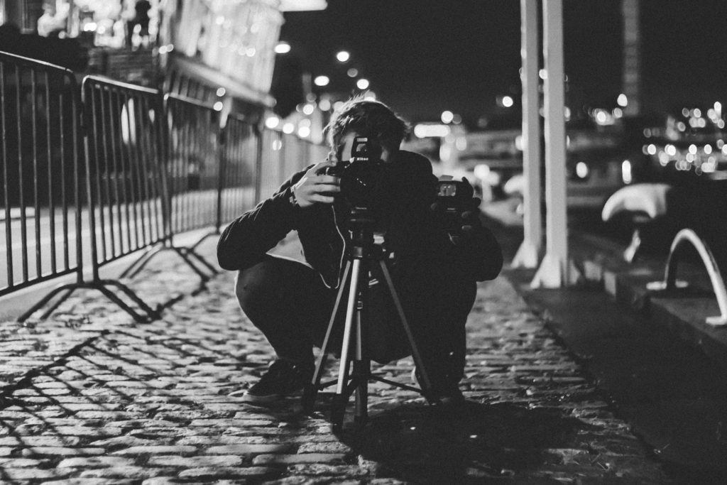 Photographer shooting street late at night