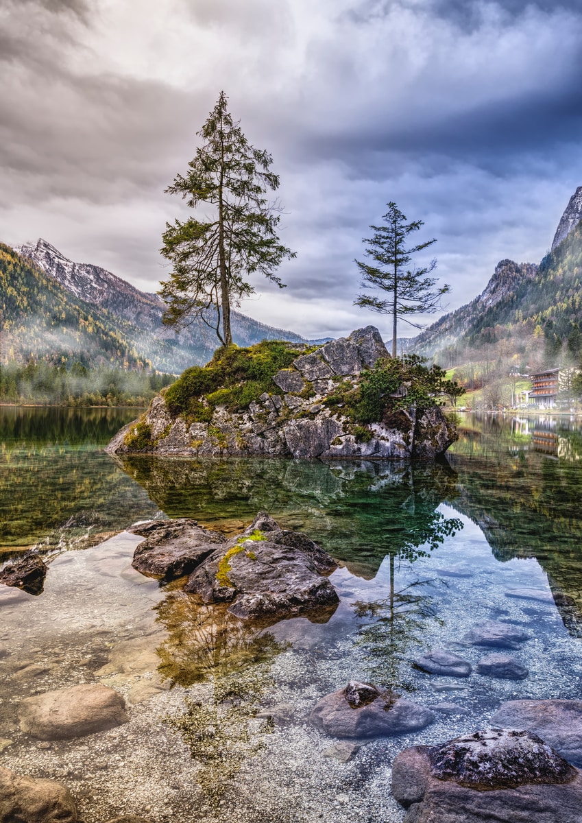 body of water within mountain range during daytime