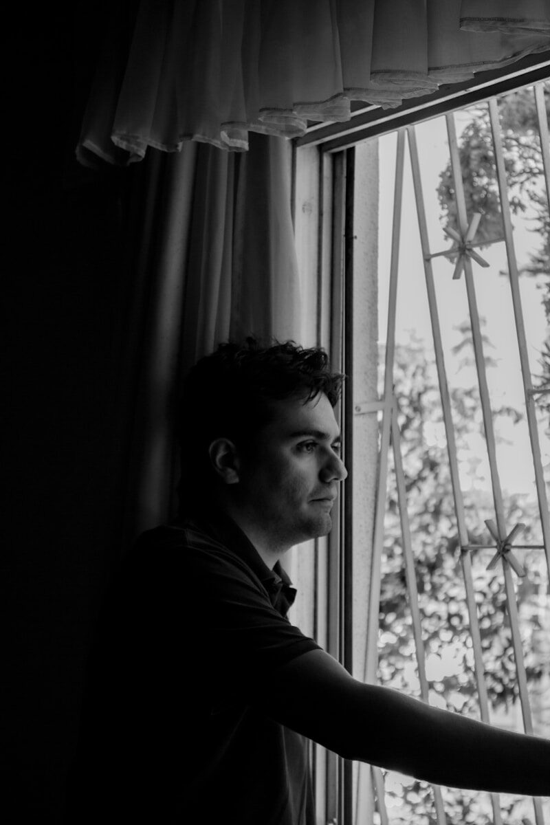 a man is looking out of a window