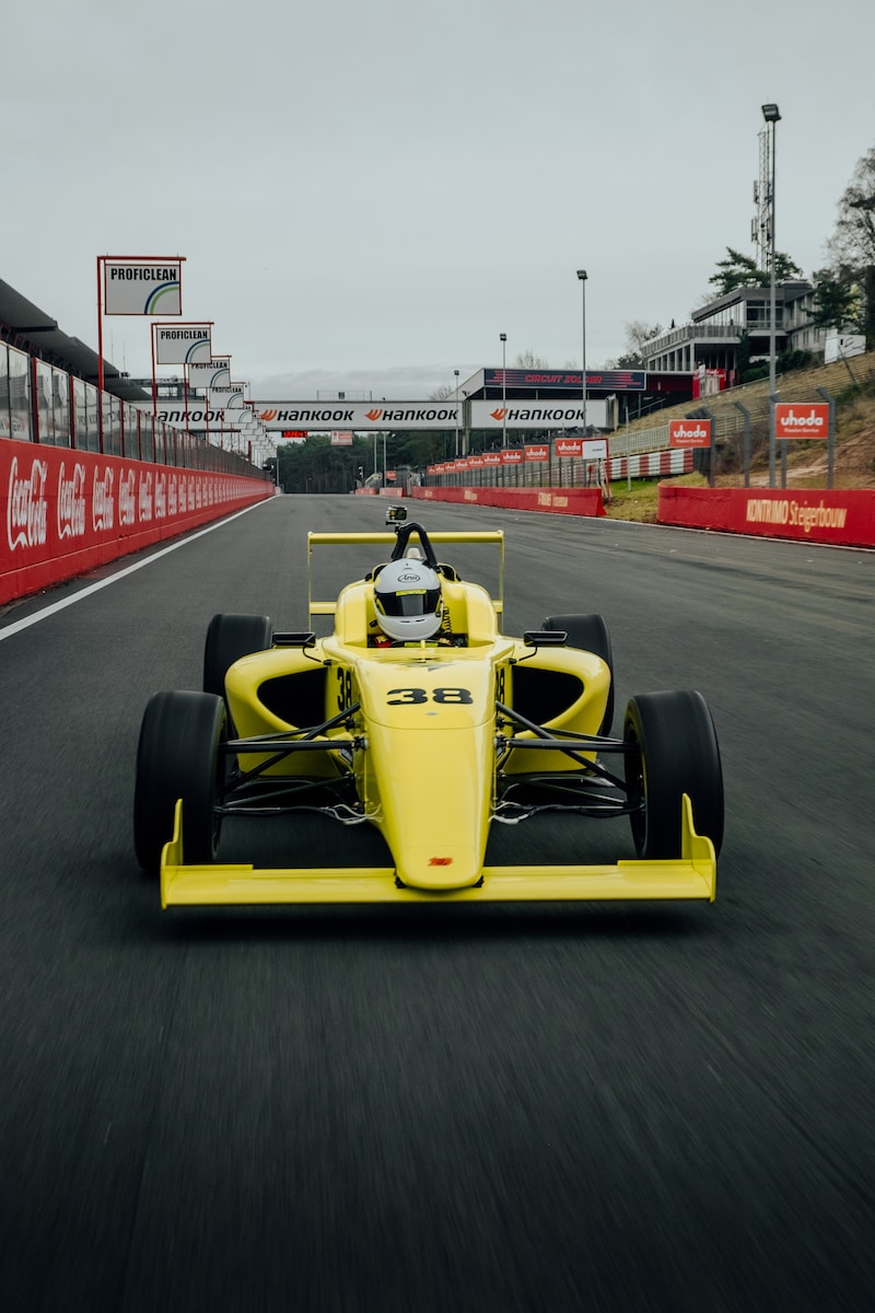 yellow and black f 1 car on road during daytime
