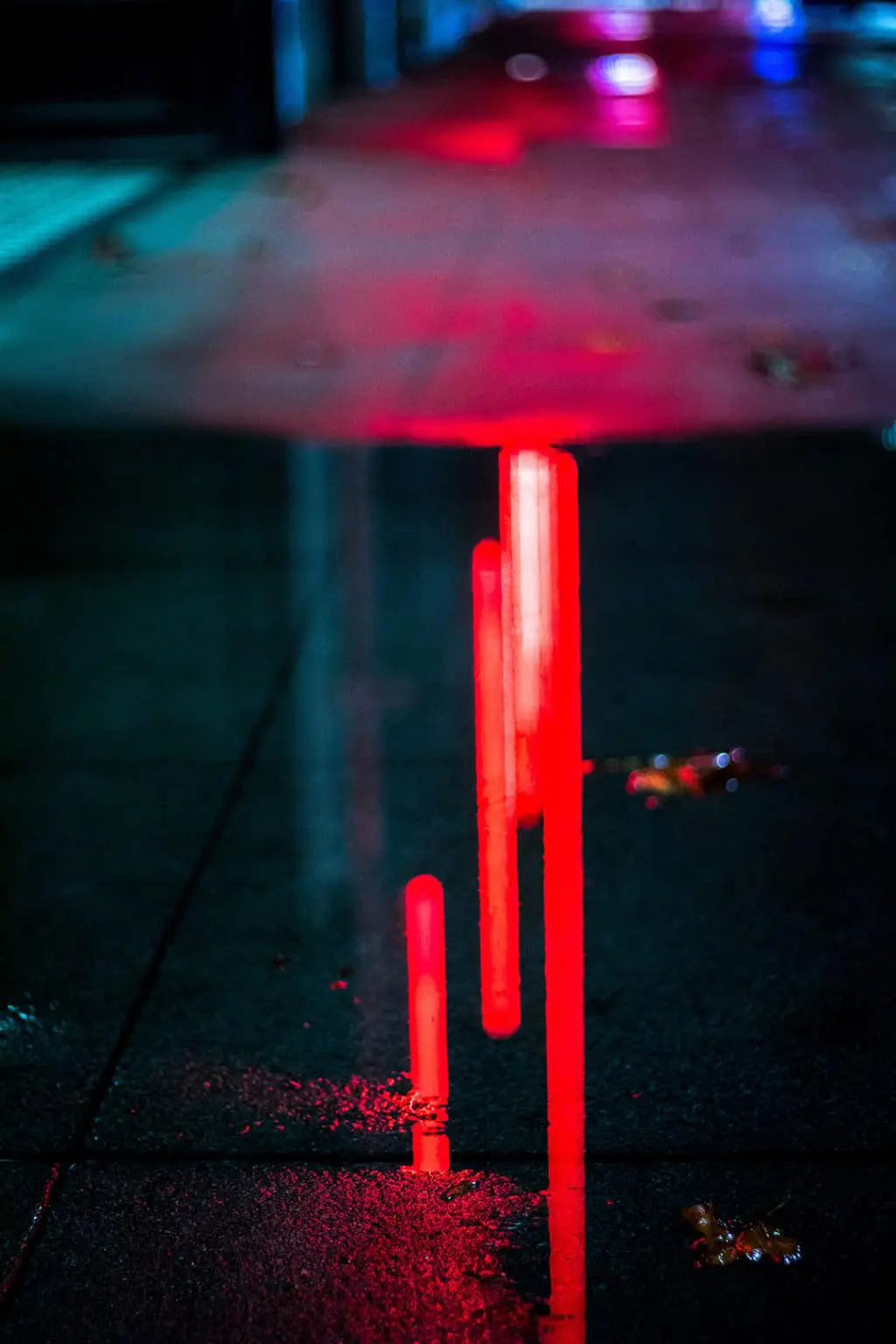 a red metal object with a red line