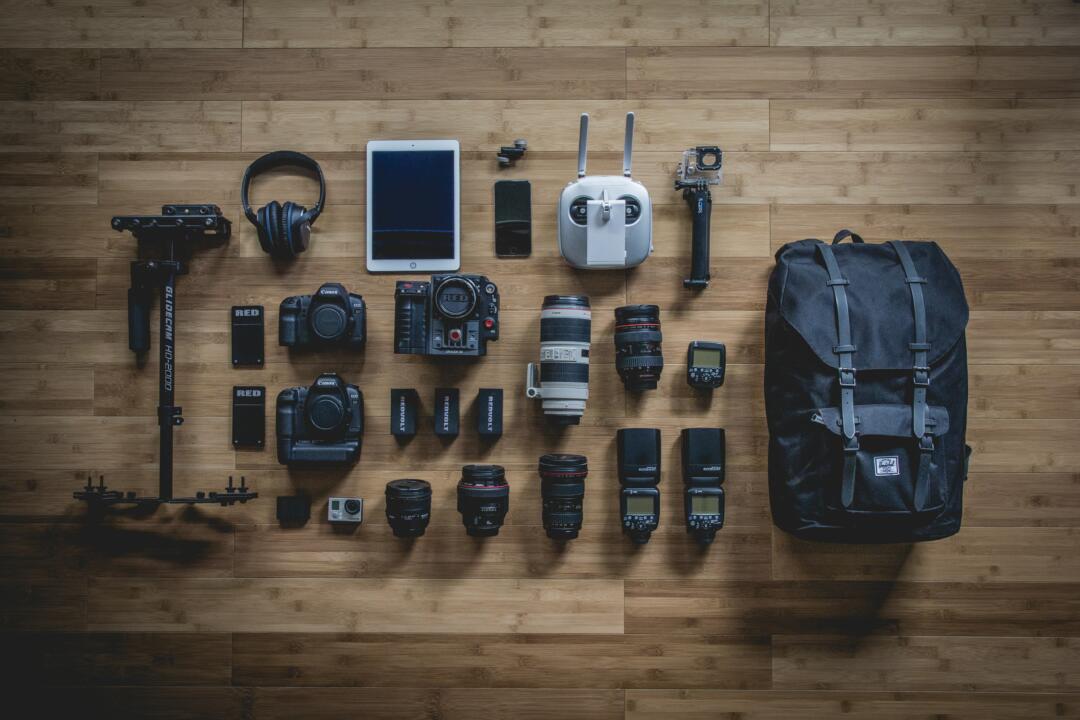 jeff-hopper-iCtJF-A5hvs-unsplash Camera gear laid out on wooden floor