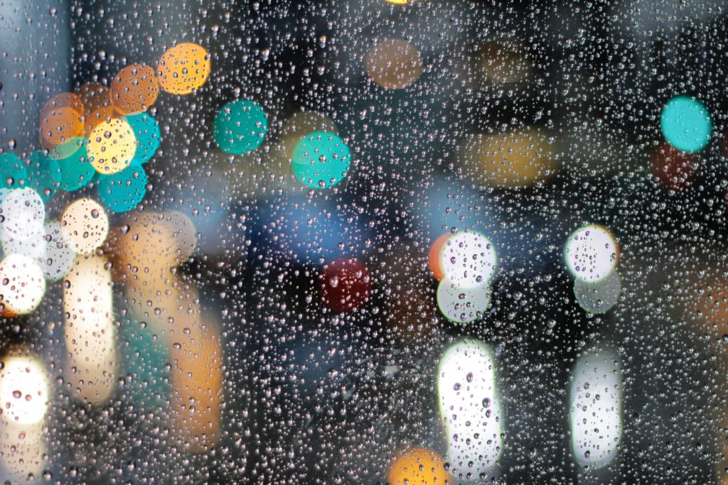 raindrops on window in city