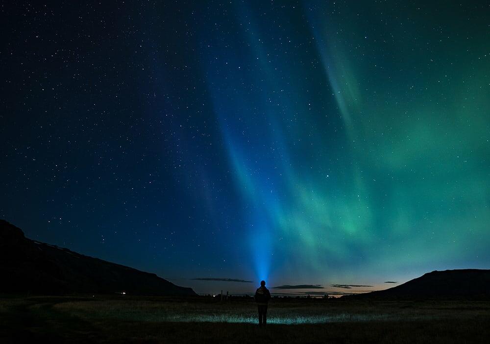 a person standing in front of a starry night sky