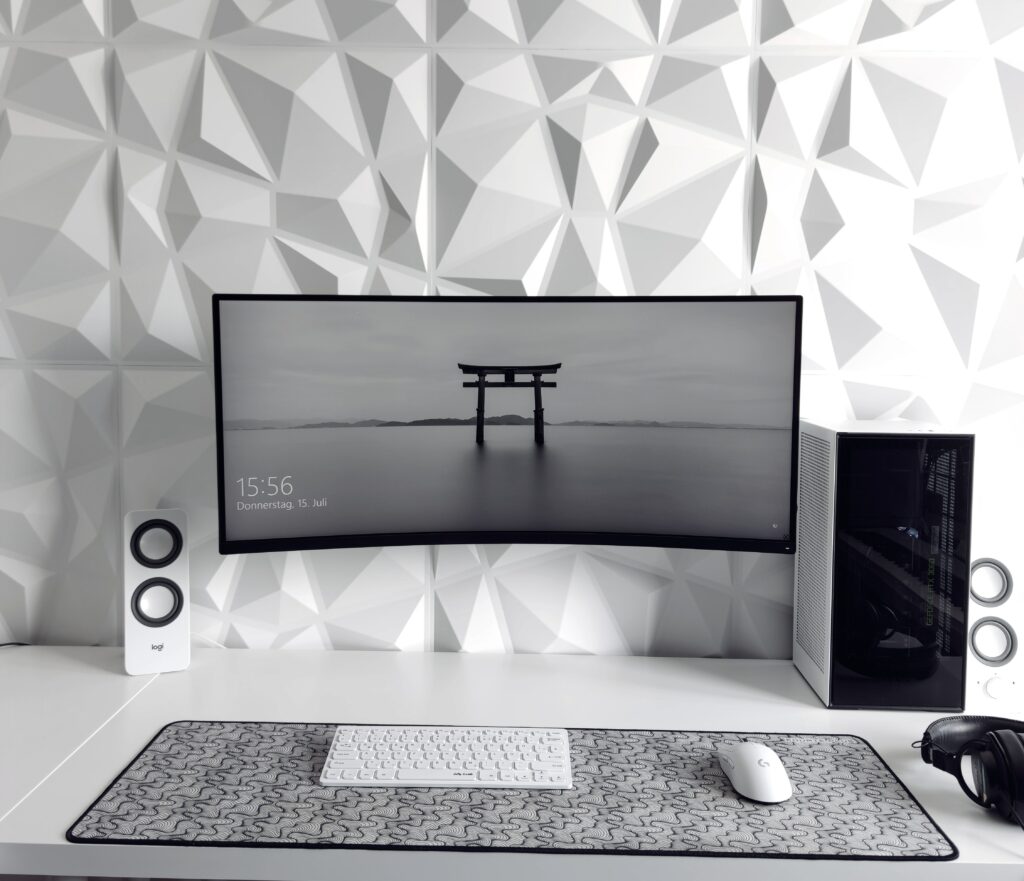 Ultra-wide monitor on an office desk in black and white 