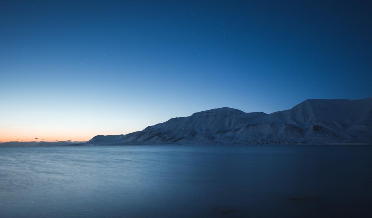 body of water beside mountain