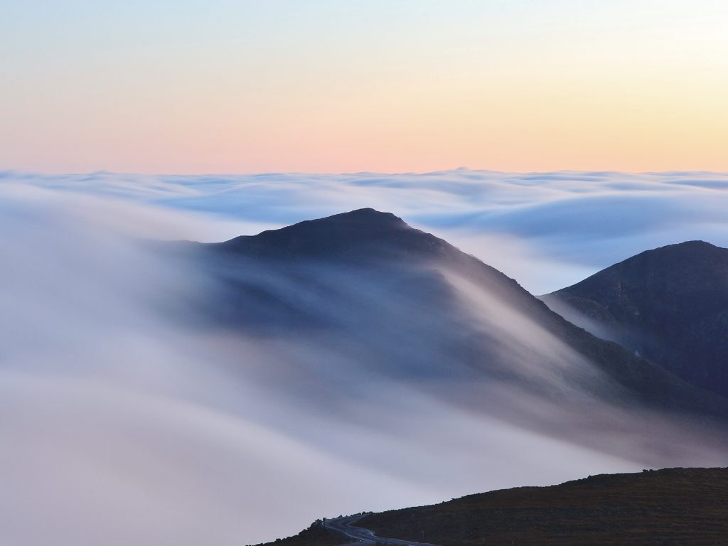 black mountains under white clouds during daytime