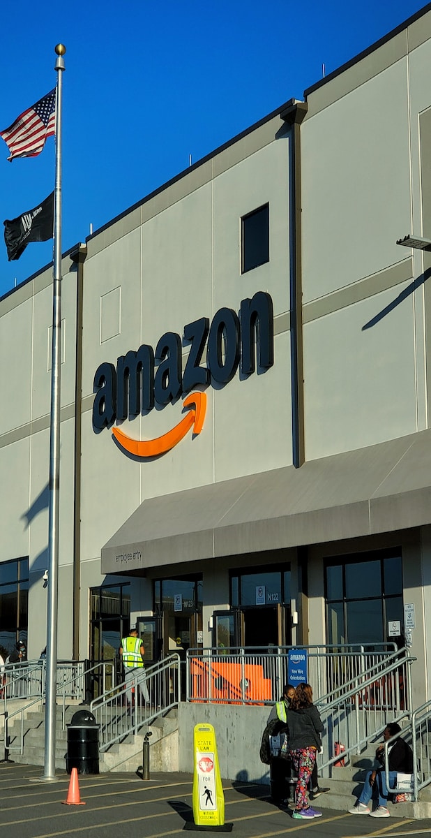 an amazon store with a person sitting in front of it