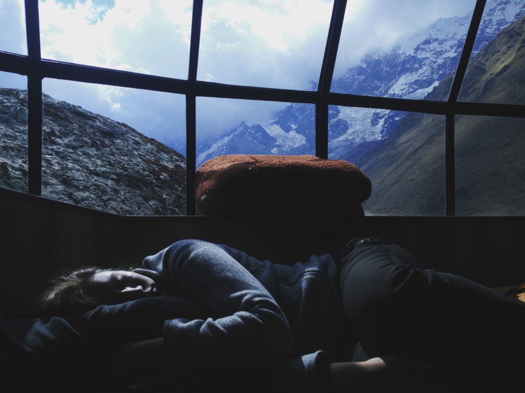 Man asleep on couch with spectacular view through window