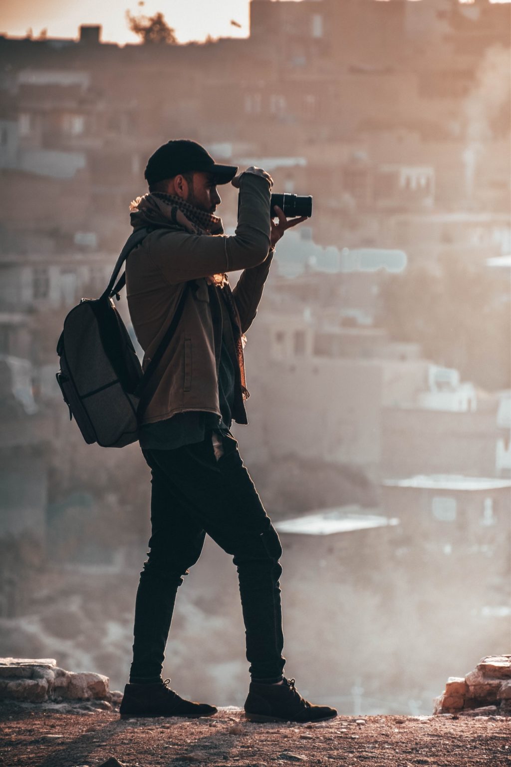 man holding black dslr camera