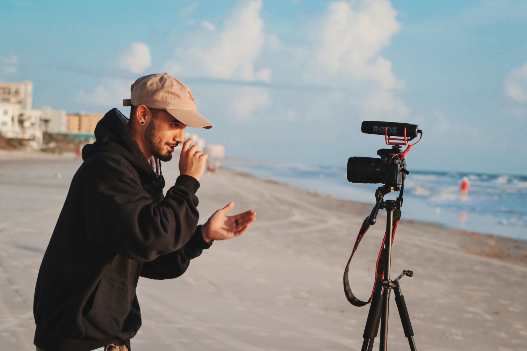 Man vlogging to camera on beach